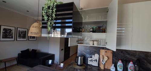 a kitchen with white cabinets and a dining room at City Centre Apartment in Rēzekne