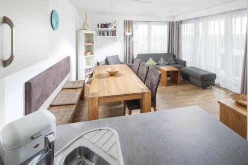 a kitchen and living room with a table and a couch at Sonnenterrasse in Juist