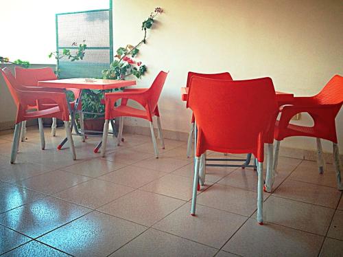 a group of red chairs and a table at Pilgrim's Guest House in Madaba