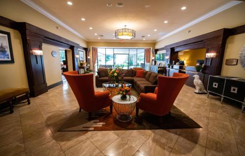 a living room filled with furniture and a large window at Holiday Inn Bar Harbor Regency Hotel, an IHG Hotel in Bar Harbor