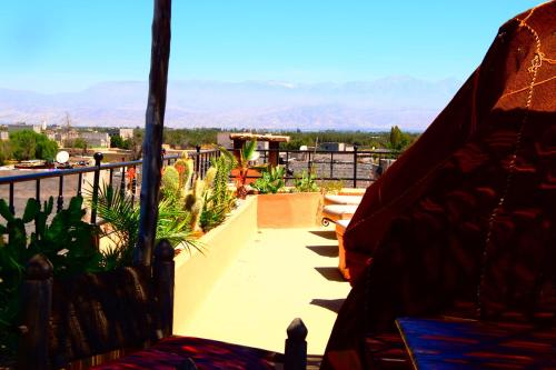a balcony with a view of a patio with plants at Riad Anma in Taroudant