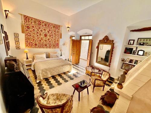 a large bedroom with a bed and a couch at Riad De La Mer in Essaouira
