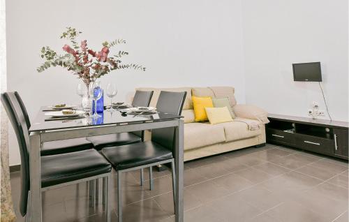 a living room with a table and a couch at Beautiful Home In El Coronil With Wifi in El Coronil