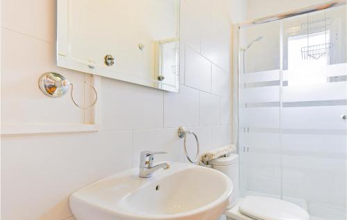 a white bathroom with a sink and a shower at Awesome Home In El Coronil With Wifi in El Coronil