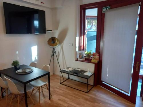 a living room with a table and chairs and a window at City center, peaceful, with free parking in Varaždin