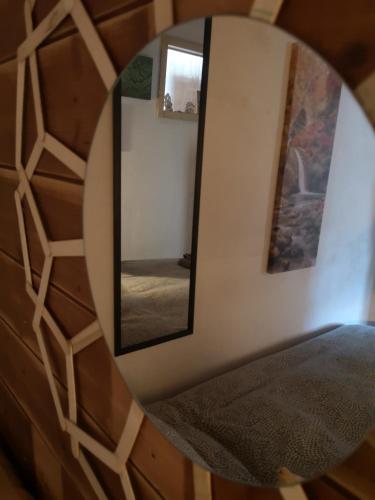 a mirror reflecting a bedroom with a bed in a room at Molise isernia è casa Sbriglio, tra cascate, laghi, fiumi e relax in Sessano Del Molise