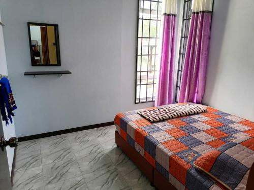 a bedroom with a bed and a mirror and windows at SMART 2.0 Homestay Pantai Kemayang Bachok in Bachok