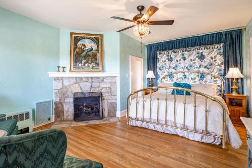 a bedroom with a bed and a fireplace at Echo Mountain Inn in Hendersonville