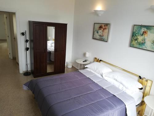 a bedroom with a bed with a purple blanket at Plaza Apartment in Salerno