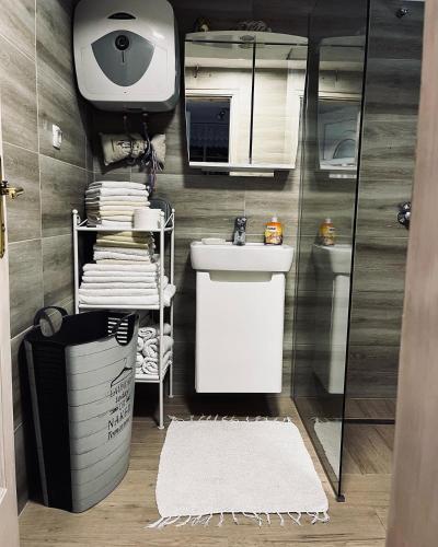 a bathroom with a sink and a toilet and a mirror at Holiday Home Amila in Visoko