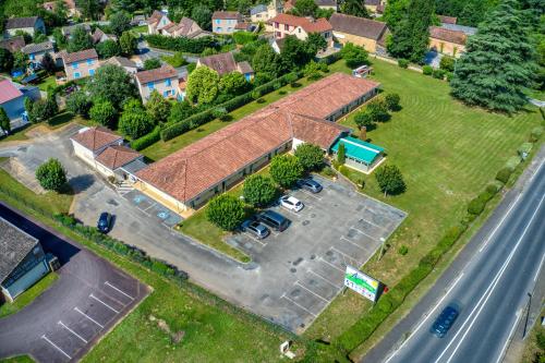 an aerial view of a house with a parking lot at FASTHOTEL Sarlat - Abbys Hotel in Sarlat-la-Canéda