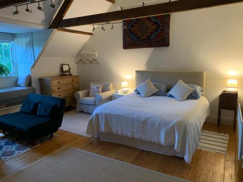 a bedroom with a large white bed and a chair at Dalton House Bed and Breakfast in Newcastle upon Tyne