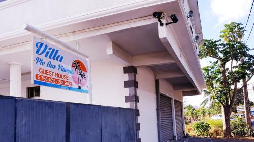 a building with a sign on the side of it at Villa Pointe Aux Piments in Pamplemousses Village