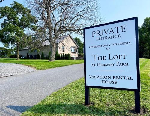 a sign in the grass next to a road at Hershey Farm Resort in Ronks