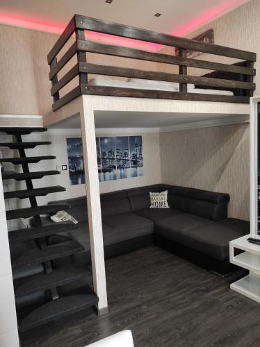 a living room with a couch and a loft bed at Corvinus Apartman in Budapest
