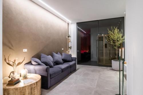 a living room with a blue couch and a table at Nest House & Relax in Civitanova Marche