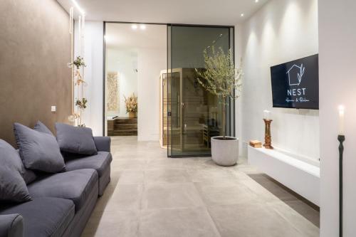 a living room with a couch and a glass door at Nest House & Relax in Civitanova Marche