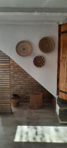 a room with three plates on a wall at Mas Midó in Sant Jaume d'Enveja