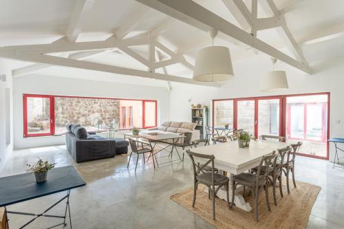 a living room with a table and chairs at Quinta de Fermil - Casas in Vouzela