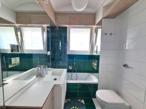 a bathroom with a sink and a tub and a toilet at La Spiga in Capri