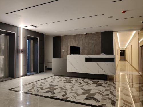 a lobby with a reception desk in a building at (41)m luxury room royal view near all services in Ash Shumaysānī