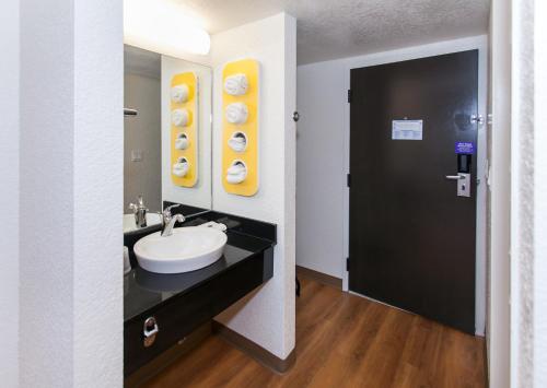 a bathroom with a sink and a mirror at Motel 6-Los Angeles, CA - Los Angeles - LAX in Inglewood