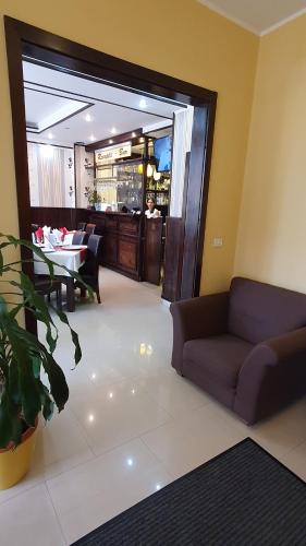 a living room with a couch and a table at Pensiunea Select in Arad