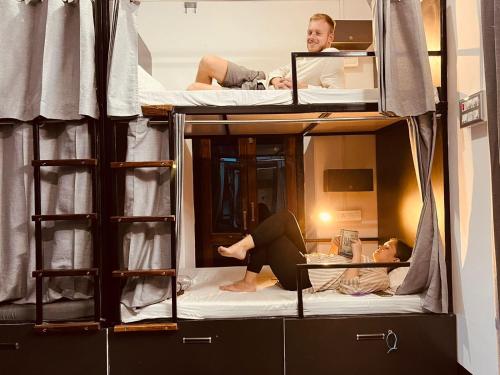a group of people sitting on bunk beds at Wanderlust Hostel & Home Stay in Varanasi