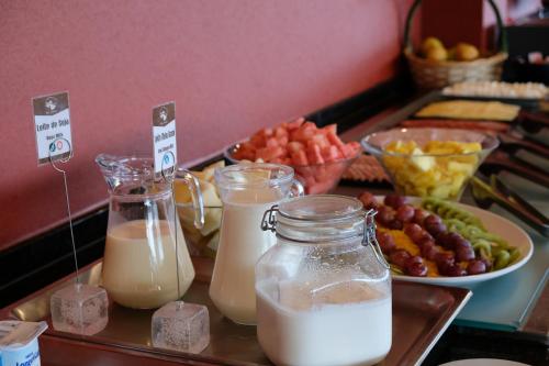a tray with milk and other food on a table at Hotel Da Montanha in Pedrógão Pequeno