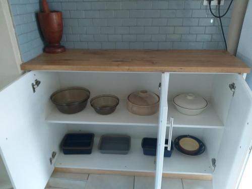 a shelf with bowls and other items on it at Prince Alfreds in Caledon