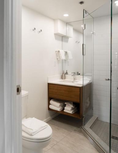 a bathroom with a toilet and a sink and a shower at Gibbons Life Accommodations in Whistler