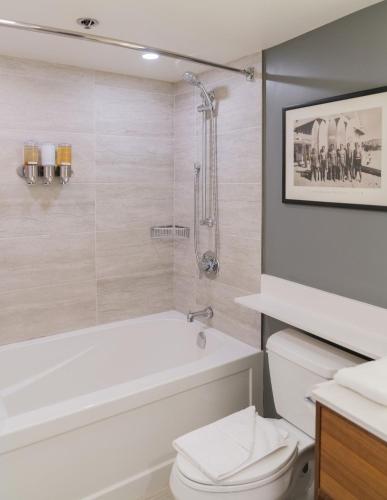 a bathroom with a tub and a toilet and a shower at Gibbons Life Accommodations in Whistler