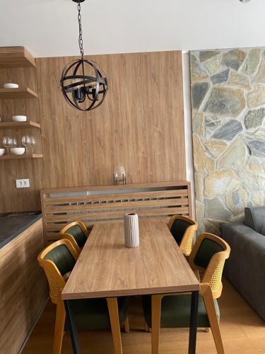 a dining room with a table and a couch at Apartman 207 in Zlatibor