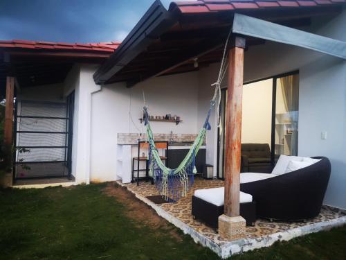 a porch with a hammock in a house at Villa Namaste, Cabaña Namaste 1 in Curití