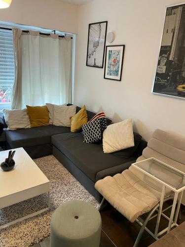 a living room with a couch and a table at Modern apartment with garden in Antwerp, 15min from City center in Antwerp