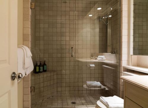 a bathroom with a shower with a toilet and a sink at Gibbons Life Accommodations in Whistler