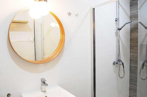 a bathroom with a mirror and a sink at Typical Canarian house with fabulous sea views in Tías