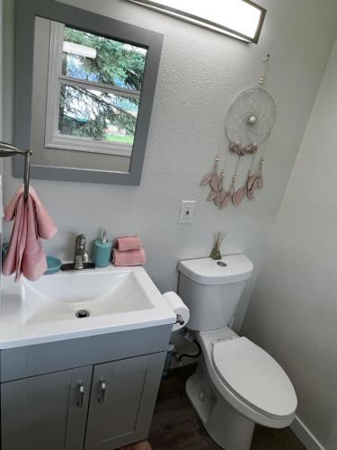 a bathroom with a white toilet and a sink at Anchorage midtown apartment- Wyoming 1 in Anchorage