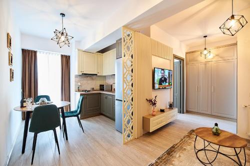 cocina y comedor con mesa y sillas en UpTown Apartments, en Iaşi