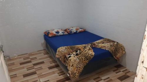a bed in a room with a leopard blanket on it at Pousada Itália in Guarujá