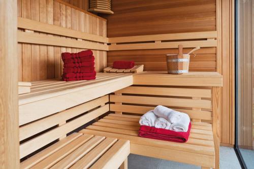 a sauna with wooden cabinets and towels in it at Hotel Florida in Lignano Sabbiadoro
