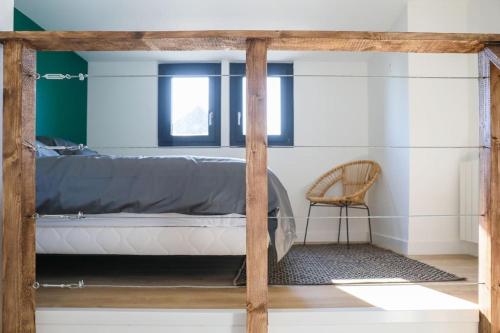 a bedroom with a bed and a chair at F2 Cosy - Entrée du Havre - 4 personnes in Le Havre