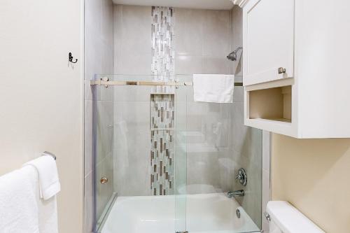 a bathroom with a shower with a glass door at Harbor Island Retreat in Port Isabel