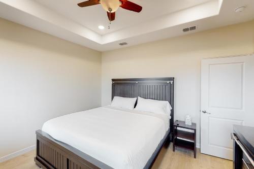 a bedroom with a bed and a ceiling fan at Harbor Island Retreat in Port Isabel