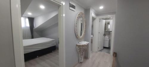 a bedroom with a mirror and a bed and a hallway at Aymira Residence Alibeyköy in Istanbul