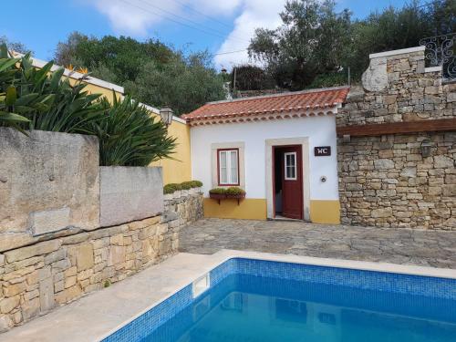 a villa with a swimming pool and a house at Casarão do Largo da Eira in Tomar