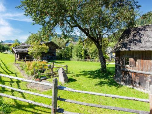 an old barn in a field next to a fence at Chalet in Oberau near Ski Slopes in Oberau
