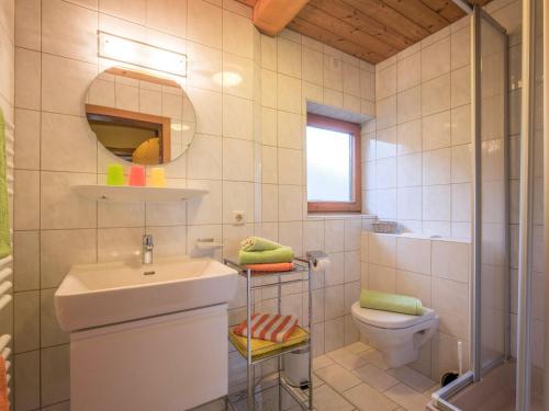 a bathroom with a sink and a toilet and a mirror at Apartment in Top Location in F gen with Balcony in Fügen