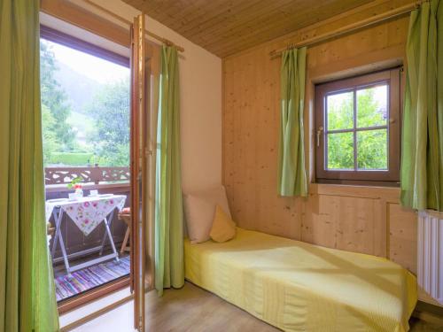 a bedroom with a bed and a window and a table at Apartment in Top Location in F gen with Balcony in Fügen