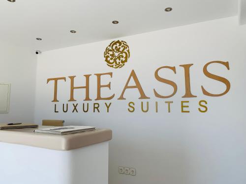 a sign for theais luxury suites on a wall at Theasis Luxury Suites in Skhoinoussa